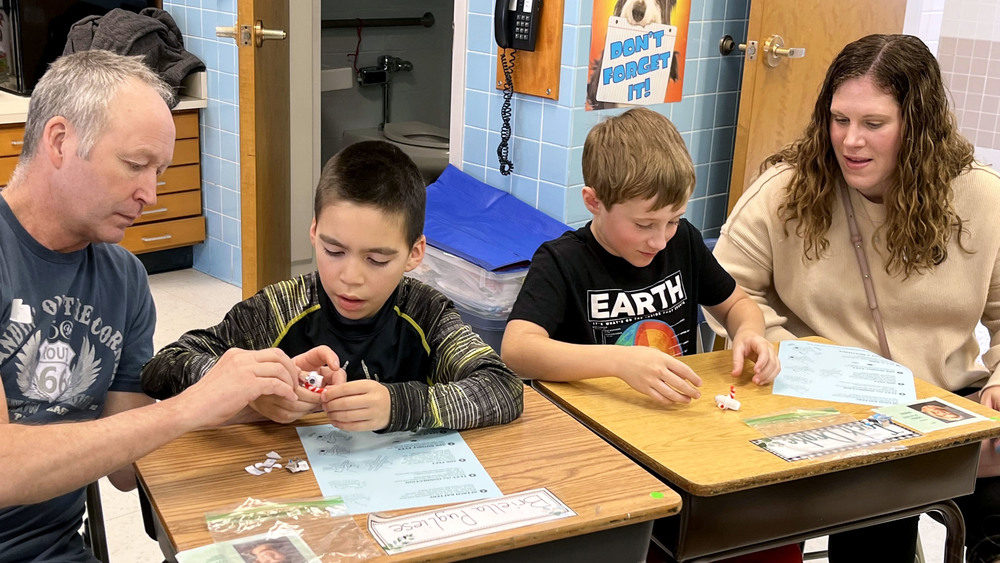 Students and family work on science-related activities