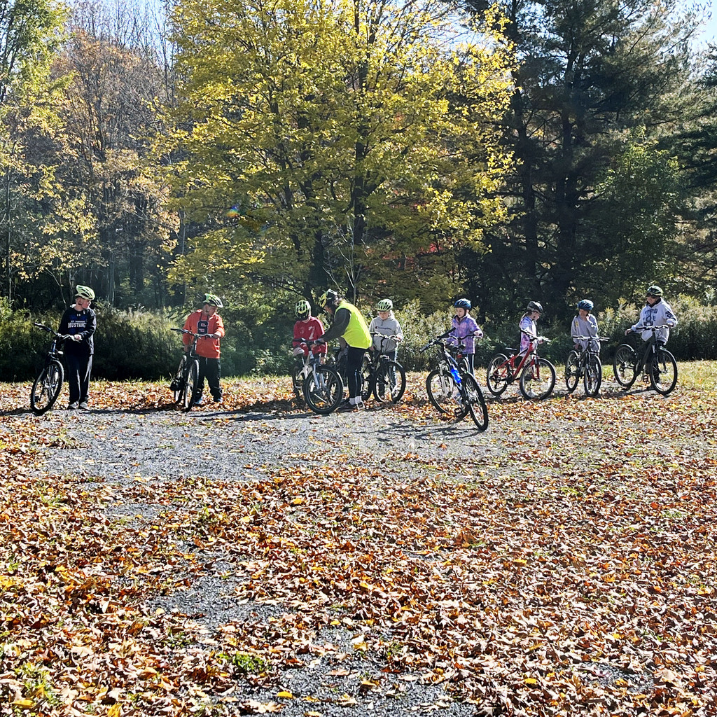 students ride bikes on trails