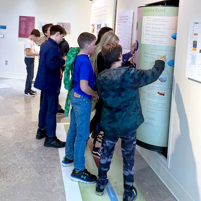 Students examine an informational artifact at Colgate