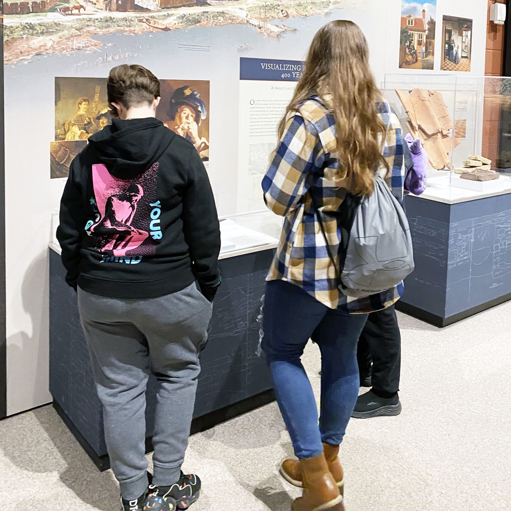 Students study artifacts on display in the museum
