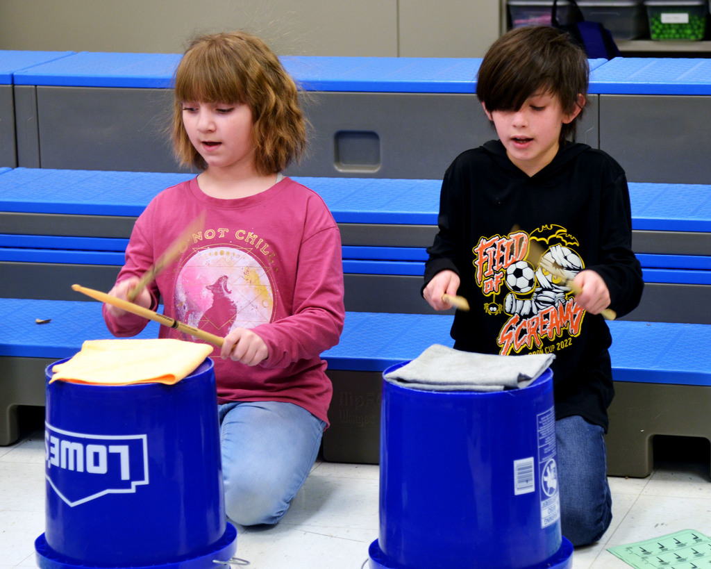 Students practice bucket drumming