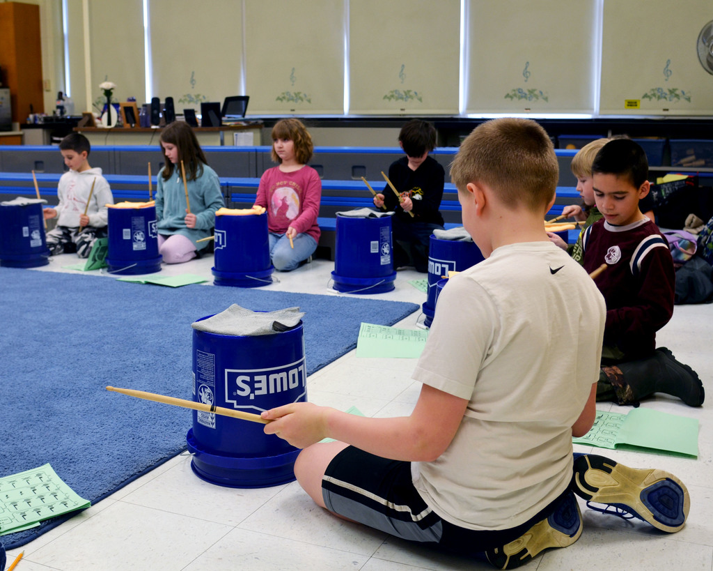 Students practice bucket drumming