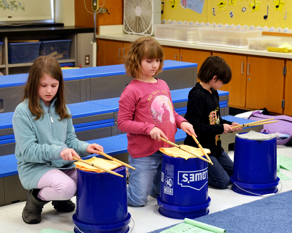 Students practice bucket drumming
