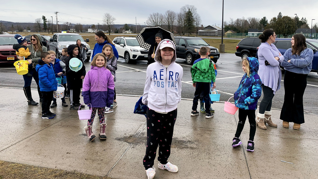 Children stand with buckets for eggs