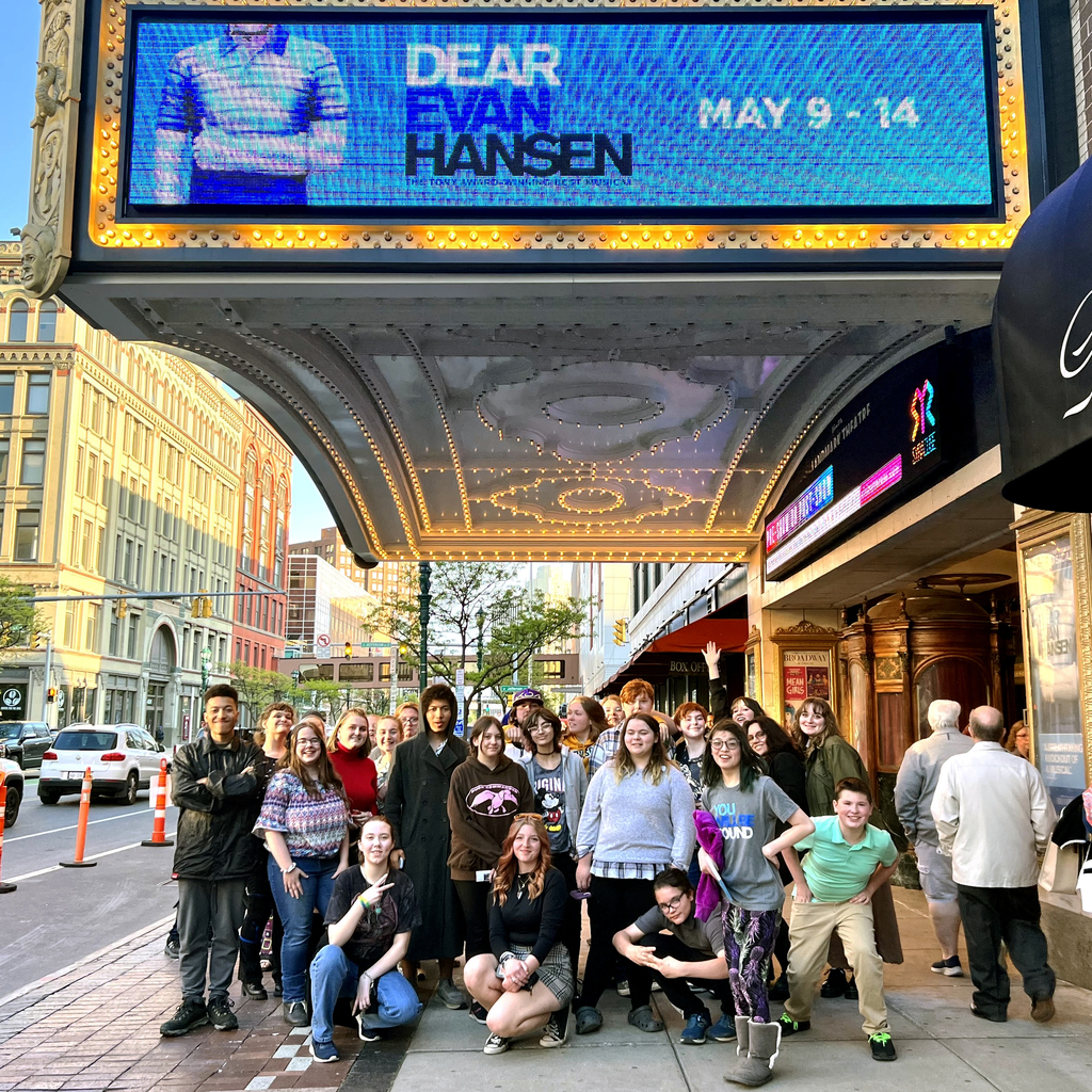 Students gather outside the theatre for a group picture.