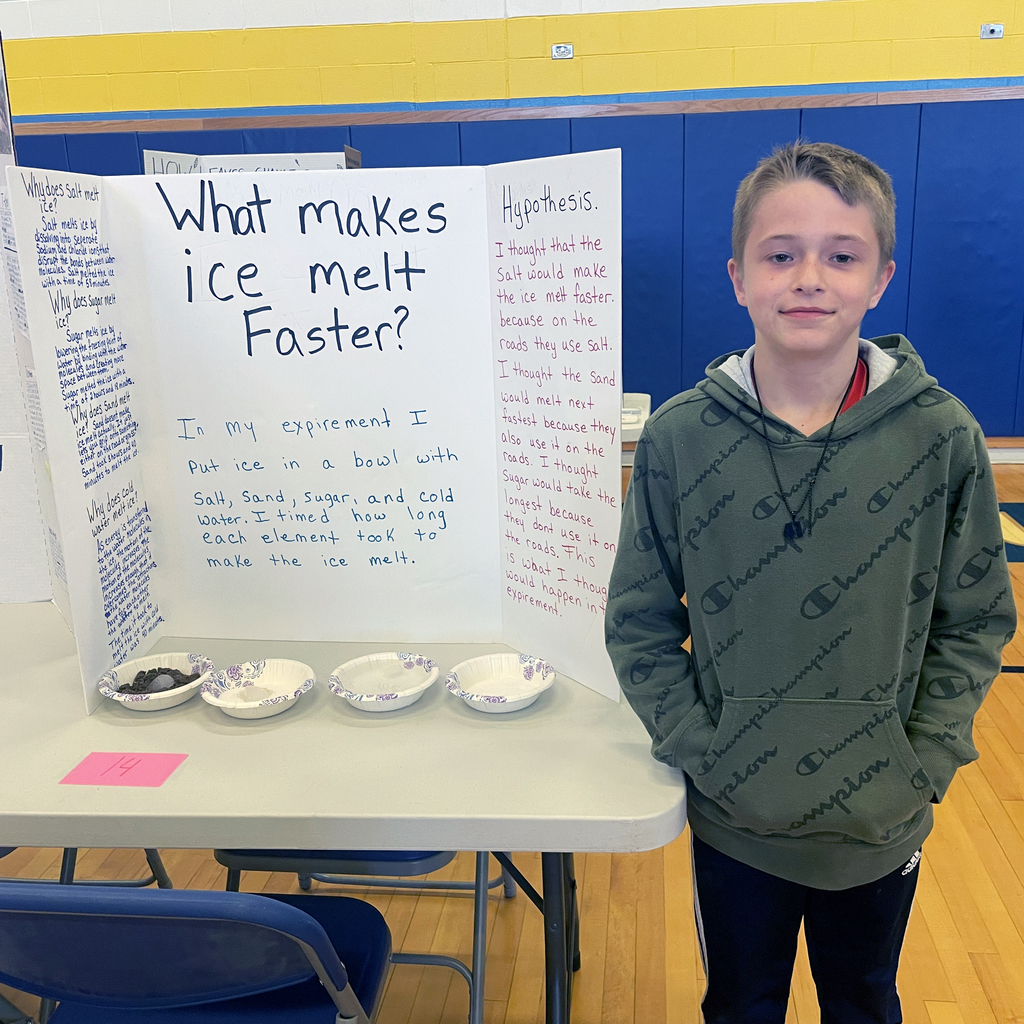 Boy stands in front of project about ice melting