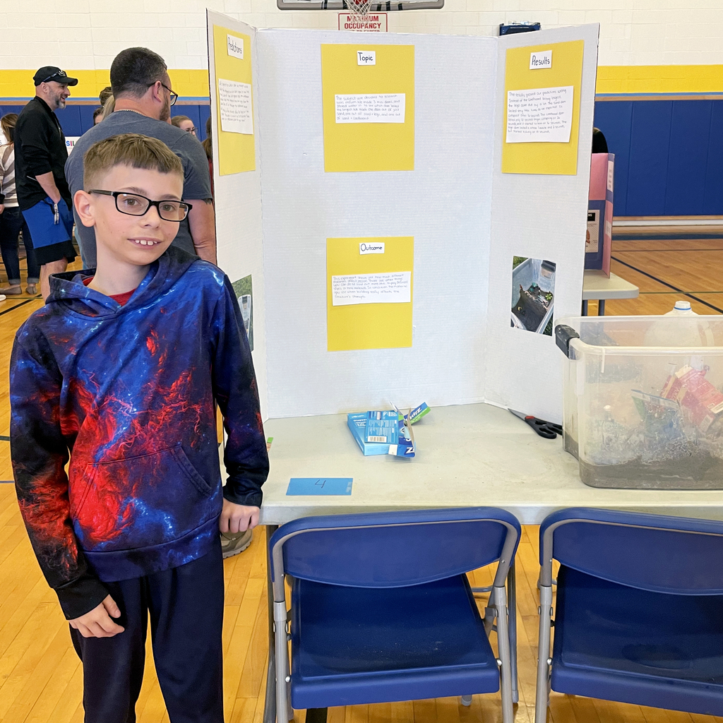 Boy stands in front of project