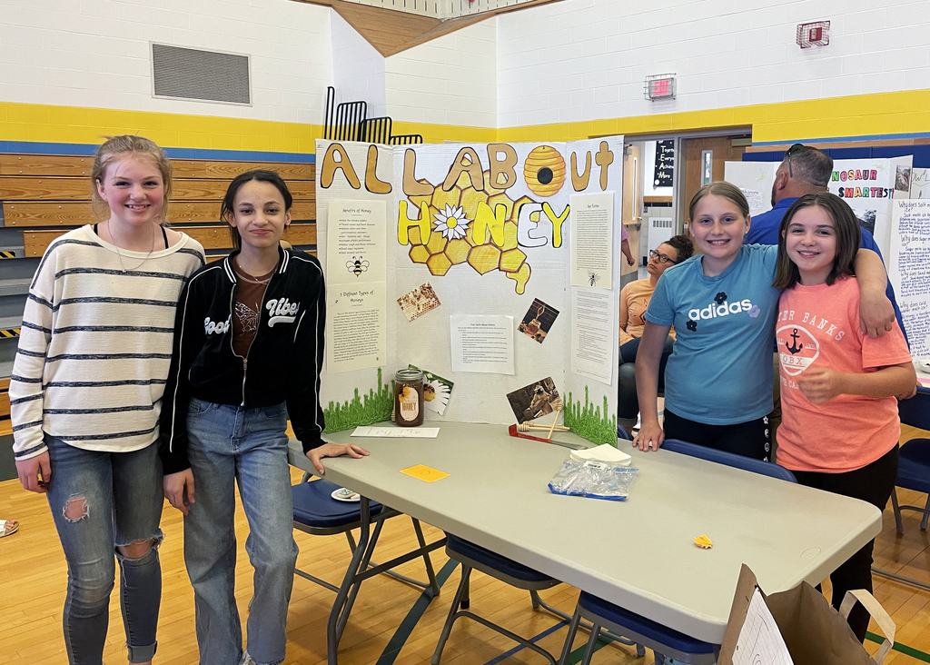 Students stand by project on honey