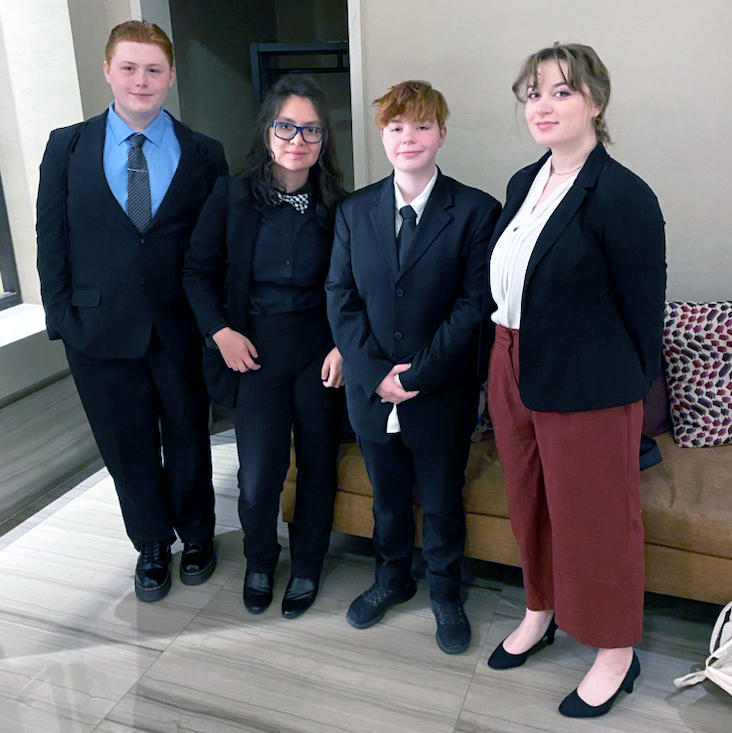 Speech and debate team in professional attire before competing