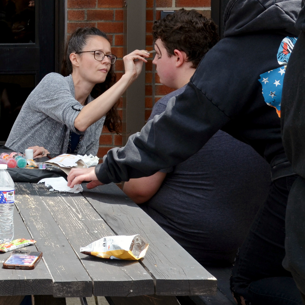 A student has their face painted