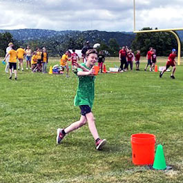 a student runs in a water relay race