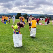 Students do a sack hop race