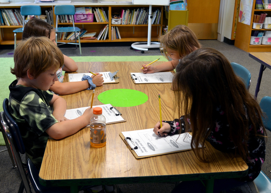 Students write observations on a worksheet
