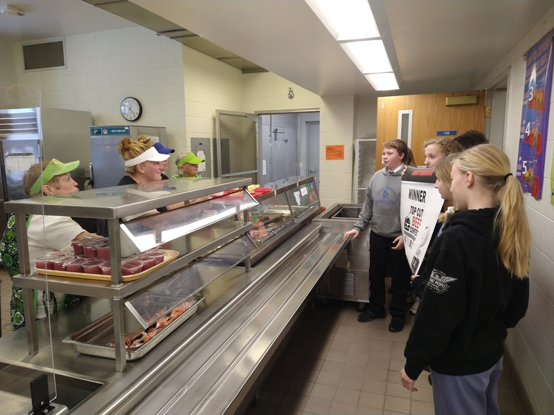 Our Top Cut Beef Contest winners showing off their 2nd place banner to the cafeteria staff. 